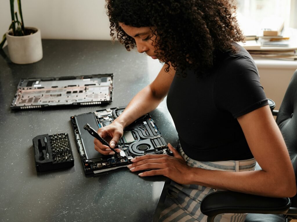 A woman sitting at a table using a cell phone