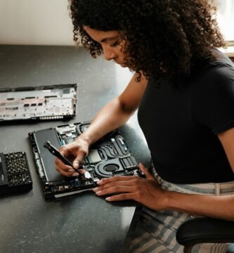 A woman sitting at a table using a cell phone